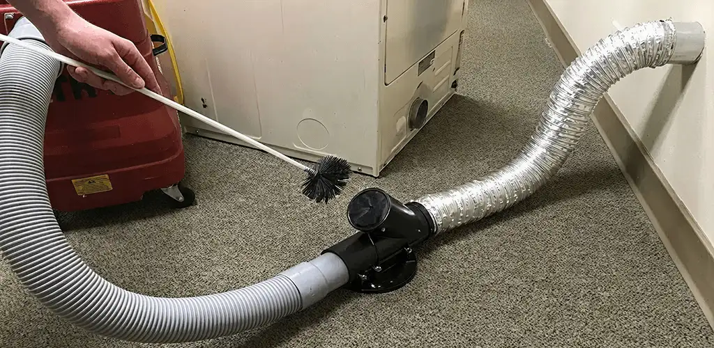 Dryer vent cleaning service removing lint from a dryer duct connection in Raleigh, NC