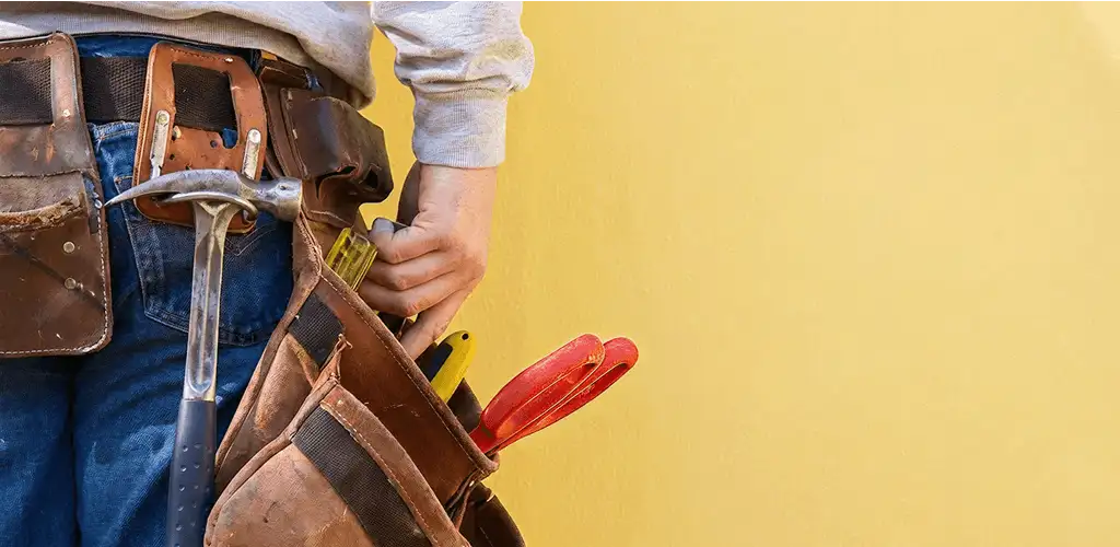 Handyman with tool belt ready for home repairs and maintenance in Raleigh, NC