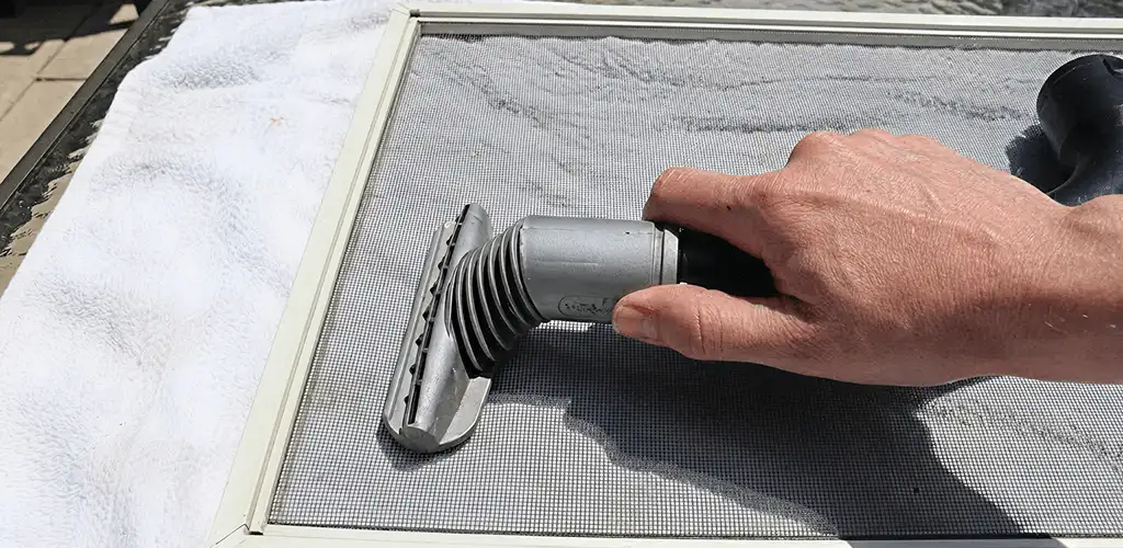 Window screen repair cleaning and fixing a damaged screen mesh in Raleigh, NC