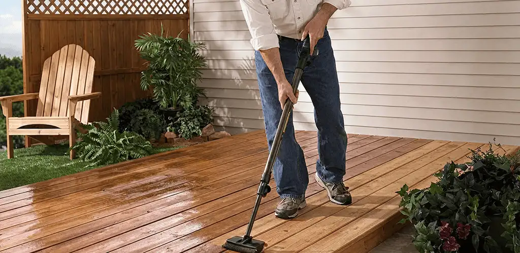 Deck staining service applying stain to a backyard wood deck in Raleigh, NC